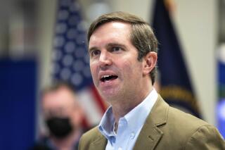 FILE- Kentucky Gov. Andy Beshear speaks while touring the FEMA State Disaster Recovery Center in Bowling Green, Ky., on Jan. 14, 2022. Kentucky posted its lowest-ever unemployment rate in April, offering more proof of the state's unprecedented economic momentum, Gov. Beshear said Thursday, May 19, 2022. (Grace Ramey/Daily News via AP, File)