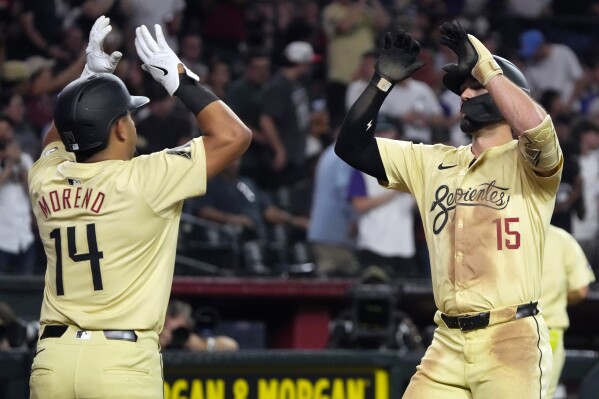 Arizona Diamondbacks' Randal Grichuk (15) celebrates with Gabriel Moreno after hitting a two run home run against the Los Angeles Angels in the third inning during a baseball game, Tuesday, June 11, 2024, in Phoenix. (AP Photo/Rick Scuteri)