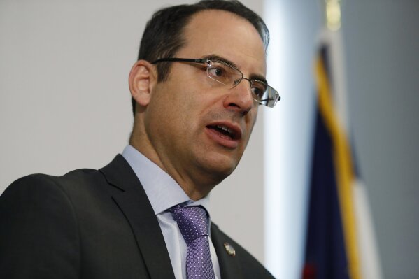 CORRECTS TO A GROUP OF 35 STATES AS WELL AS THE DISTRICT OF COLUMBIA AND TERRITORIES OF GUAM AND PUERTO RICO FILED, INSTEAD OF 38 STATES  FILE - In this Oct. 7, 2019, file photo, Colorado Attorney General Phil Weiser speaks during a news conference in Denver. A group of 35 states as well as the District of Columbia and the territories of Guam and Puerto Rico filed an anti-trust lawsuit against Google on Thursday, Dec. 17, 2020, alleging that the search giant has an illegal monopoly over the online search market that hurts consumers and advertisers. The lawsuit, announced by Weiser, was filed in federal court in Washington, D.C. by states represented by bipartisan attorneys general. (AP Photo/David Zalubowski, File)