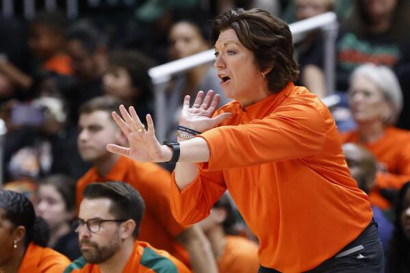 FILE - Miami head coach Katie Meier yells during the second half of an NCAA college basketball game against Notre Dame, Thursday, Dec. 29, 2022, in Coral Gables, Fla. Miami’s women’s basketball program has been placed on probation for one year, after the school and NCAA said coaches inadvertently helped arrange impermissible contact between a booster and two players before they signed with the Hurricanes. But coach Katie Meier — who already served a three-game suspension at the start of this season in anticipation of the NCAA’s decision — will not miss any more time. (AP Photo/Rhona Wise, File)