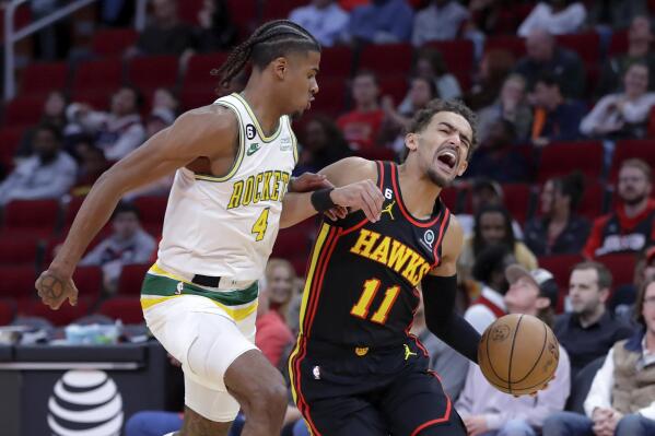 Atlanta Hawks guard Trae Young (11) reacts as he drives around Houston Rockets guard Jalen Green (4) during the first half of an NBA basketball game Friday, Nov. 25, 2022, in Houston. (AP Photo/Michael Wyke)