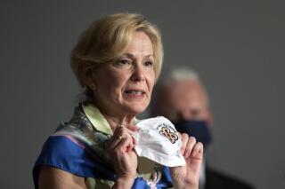 FILE - White House coronavirus response coordinator Dr. Deborah Birx holds her face mask as she speaks during a White House Coronavirus Task Force briefing in Washington on  July 8, 2020. Birx has a memoir coming out this spring titled “Silent Invasion:  The Untold Story of The Trump Administration, COVID-19, and Preventing the Next Pandemic Before It’s Too Late." It will center on her contentious time as White House coronavirus task force coordinator in the administration of President Donald Trump. (AP Photo/Manuel Balce Ceneta, File)