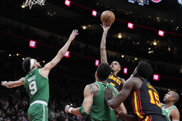 Atlanta Hawks guard Dejounte Murray (5) shoots and scores against the Boston Celtics during the second half of Game 4 of a first-round NBA basketball playoff series, Sunday, April 23, 2023, in Atlanta. (AP Photo/Brynn Anderson)