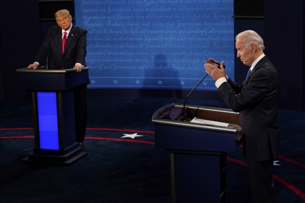 FILE - Democratic presidential candidate former Vice President Joe Biden, right, answers a question as President Donald Trump listens during the second and final presidential debate Oct. 22, 2020, in Nashville, Tenn. Twelve news organizations issued a joint statement calling on the presumptive presidential nominees President Biden and former President Trump to agree to debates during the 2024 campaign. ABC, CBS, CNN, Fox, PBS, NBC, NPR and The Associated Press all signed on to the letter. (AP Photo/Morry Gash, Pool, File)