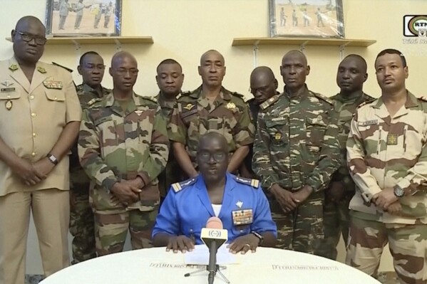 FILE - In this image taken from video provided by ORTN, Col. Maj. Amadou Abdramane, front center, makes a statement late Wednesday, July 26, 2023, in Niamey, Niger, as a delegation of military officers appeared on Niger State TV to read out a series of communiques announcing their coup d'etat. Niger's junta said Saturday, March 16, 2024, the U.S. military presence in the country is no longer justified, making the announcement on state television after holding high-level talks with U.S. diplomatic and military officials during the week. (ORTN via AP, File)