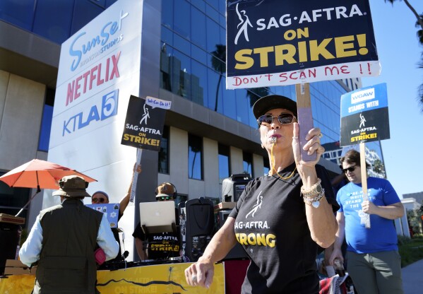 Striking SAG-AFTRA member Karen Brown participates in a picket line outside Netflix studios, Wednesday, Nov. 8, 2023, in Los Angeles. (AP Photo/Chris Pizzello)