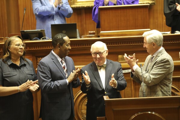 From left to right, South Carolina Sen. Margie Bright Matthews, D-Walterboro; Sen. Darrell Jackson, D-Hopkins, Senate Chaplin James St. John; and Sen, Nikki Setzler, D-West Columbia, honor St. John at the end of the 2024 session on Thursday, May 9, 2024, in Columbia, S.C. (AP Photo/Jeffrey Collins)