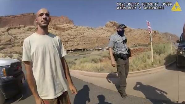 This police camera video provided by The Moab Police Department shows Brian Laundrie  talking to a police officer after police pulled over the van he was traveling in with his girlfriend, Gabrielle “Gabby” Petito, near the entrance to Arches National Park on Aug. 12, 2021. The couple was pulled over while they were having an emotional fight. Petito was reported missing by her family a month later and is now the subject of a nationwide search. (The Moab Police Department via AP)