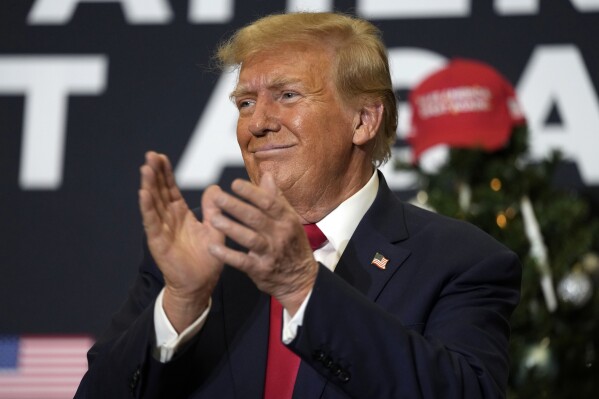 FILE - Former President Donald Trump reacts to supporters during a commit to caucus rally, Tuesday, Dec. 19, 2023, in Waterloo, Iowa. An appeals court said Tuesday, Jan. 2, 2024, that Michael Cohen can't hold Trump, his former boss, liable for allegedly jailing him in retaliation for writing a tell-all memoir. (AP Photo/Charlie Neibergall, File)