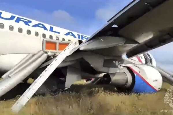 In this image made from video provided by Russian Emergency Situations Ministry press service, an Airbus A320 of Ural Airlines is seen after emergency landing near Ubinskoye village, Novosibirsk Region, Russia, Tuesday, Sept. 12, 2023. An Airbus A320 with 161 passengers onboard has performed an emergency landing in a field in the Novosibirsk Region, according to Ural Airlines, TASS reported. (Ministry of Emergency Situations press service via AP)