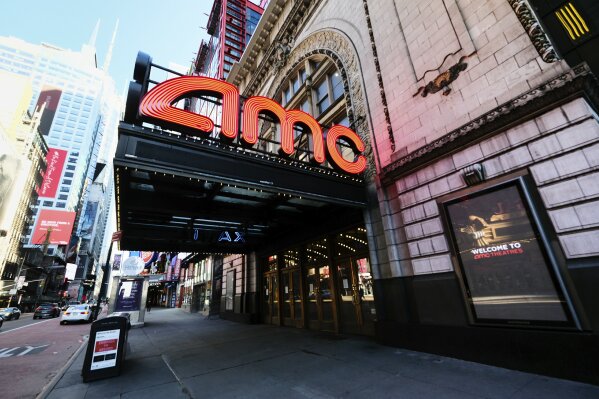 FILE - In this May 13, 2020 file photo, AMC Empire 25 theatre appears on 42nd Street in New York. The nation’s largest movie theater chain changed its position on mask-wearing less than a day after the company became a target on social media for saying it would defer to local governments on the issue. AMC Theaters CEO Adam Aron said Friday that its theaters will require patrons to wear masks upon reopening, which will begin in July. (Photo by Evan Agostini/Invision/AP, File)