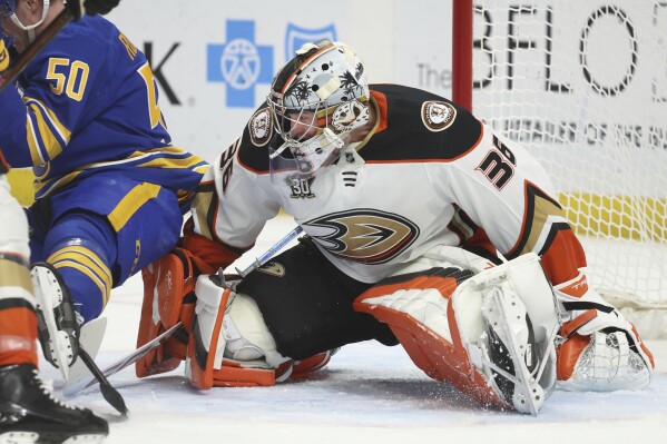 Anaheim Ducks goaltender John Gibson (36) makes a save in front of Buffalo Sabres' Eric Robinson (50) during the first period of an NHL hockey game against the Buffalo Sabres Monday, Feb. 19, 2024, in Buffalo, N.Y. (AP Photo/Jeffrey T. Barnes)
