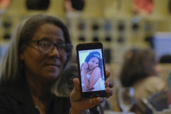 Rosa Hernández shows a photo of her late daughter Rosaura Almonte in Santo Domingo, Dominican Republic, Sunday, Dec. 10, 2023. Hernández asked for an exception for her daughter to get an abortion in order to use chemotherapy as her leukemia treatment, but was denied because that would put the fetus at risk of death in the Dominican Republic where abortion is criminalized without exceptions. Both her daughter and daughter's 13-week-old fetus died in 2012. (AP Photo/Ricardo Hernandez)