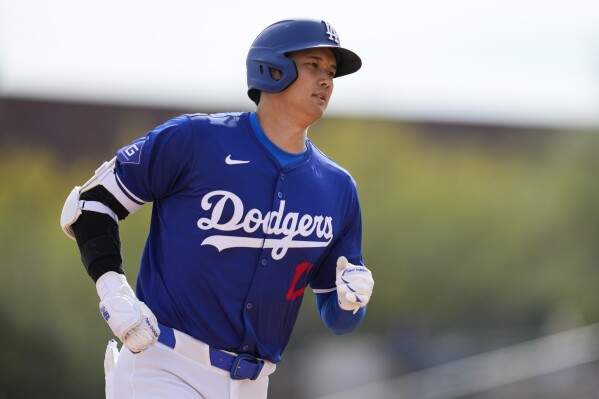 Los Angeles Dodgers designated hitter Shohei Ohtani runs the bases after hitting a home run during the fifth inning of a spring training baseball game against the Chicago White Sox in Phoenix, Tuesday, Feb. 27, 2024. Jose Ramos also scored. (AP Photo/Ashley Landis)