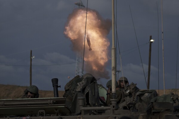 FILE - Israeli soldiers fire a mortar shell from southern Israel towards the Gaza Strip, in a position near the Israel-Gaza border , on Jan. 3, 2024. (AP Photo/Leo Correa, File)