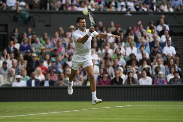 Serbia's Novak Djokovic plays a return to Australia's Jordan Thompson in the men's singles match on day three of the Wimbledon tennis championships in London, Wednesday, July 5, 2023. (AP Photo/Alastair Grant)