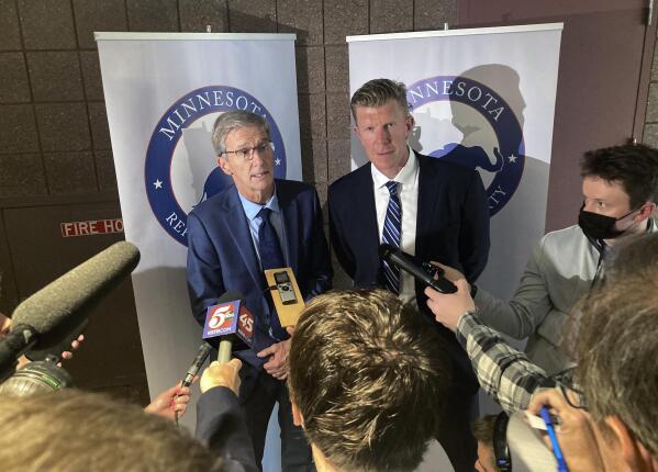 Endorsed Minnesota GOP gubernatorial candidate Dr. Scott Jensen, left, and his running mate, former Minnesota Viking and former Baltimore Raven Matt Birk, speak with reporters after Jensen won the party's backing, Saturday, May 14, 2022, at the Minnesota GOP State Convention in Rochester, Minn. (AP Photo/Steve Karnowski)