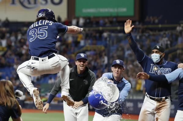 Tampa Bay Rays right fielder Brett Phillips (35) reacts after throwing a  ball to a fan before a baseball game against the Texas Rangers, Sunday,  June 6, 2021, in Arlington, Texas. Tampa
