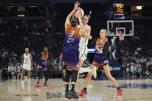 Minnesota Lynx forward Alanna Smith, center, right, is fouled by Phoenix Mercury guard Diana Taurasi (3) during the second half of a WNBA basketball game Friday, May 31, 2024, in Minneapolis. (AP Photo/Abbie Parr)