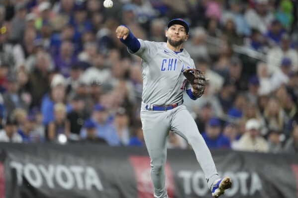 Chicago Cubs third baseman Nick Madrigal throws to first base to put out Colorado Rockies' Ezequiel Tovar to end the third inning of a baseball game Monday, Sept. 11, 2023, in Denver. (AP Photo/David Zalubowski)