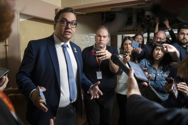 FILE - Rep. George Santos, R-N.Y., speaks to reporters as he leaves a caucus meeting of Republican House members on Capitol Hill, Oct. 12, 2023 in Washington. (AP Photo/Mark Schiefelbein, File)
