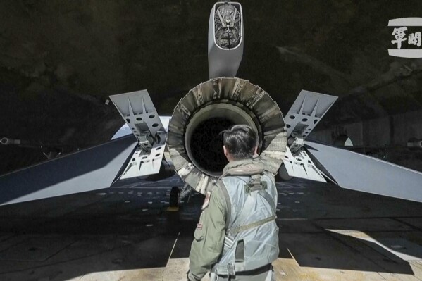 In this grab from video released by the Taiwan Military News Agency, a pilot checks on a F-16s at Hualien Airbase in Taiwan's southeastern Hualien county, Sunday, Aug. 20, 2023. Taiwan deployed aircraft and vessels and activated land-based missile systems after the Chinese military launched drills around Taiwan on Saturday as a "stern warning" over what it called collusion between "separatists and foreign forces," its defense ministry said, days after the island's vice president stopped over in the United States. (Taiwan Military News Agency via AP)