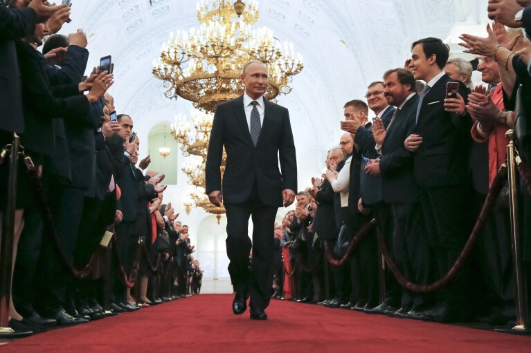 FILE - In this Monday, May 7, 2018 file photo, Vladimir Putin enters to take the oath during his inauguration ceremony as Russia's new president in the Grand Kremlin Palace in Moscow, Russia. With most opposition figures either in jail or abroad and many independent media outlets blocked, the Kremlin maintains a tight control over the country's political system and the vote is all but guaranteed to see President Vladimir Putin, 71, cement his place in power until at least 2030. (AP Photo/Alexander Zemlianichenko, Pool, File)