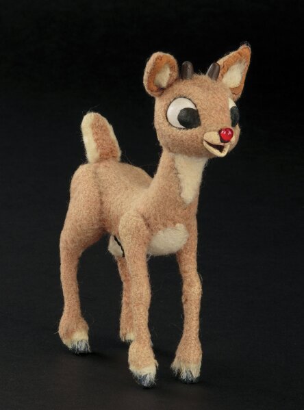 This image released by Profiles in History shows a Rudolph reindeer puppet used in the filming of the 1964 Christmas special "Rudolph the Red-Nosed Reindeer." The soaring reindeer and Santa Claus figures who starred in in the perennially beloved stop-motion animation Christmas special “Rudolph the Red Nosed Reindeer” are going up for auction.Auction house Profiles in History announced Thursday that a 6-inch-tall Rudolph and 11-inch-tall Santa used to animate the 1964 TV special are being sold together in the auction that starts Nov. 13 and are expected to fetch between $150,000 and $250,000.  (Profiles in History via AP)