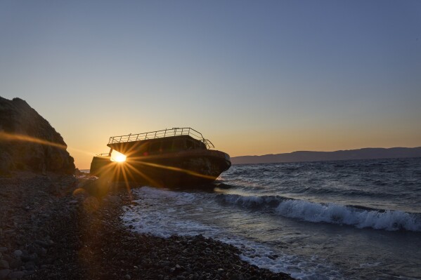 A wrecked vessel that was carrying migrants from Turkey in 2015 lies on the shore at Skala Sikamias, on the island of Lesbos, Greece, May 14, 2025. (AP Photo/Petros Giannakouris)
