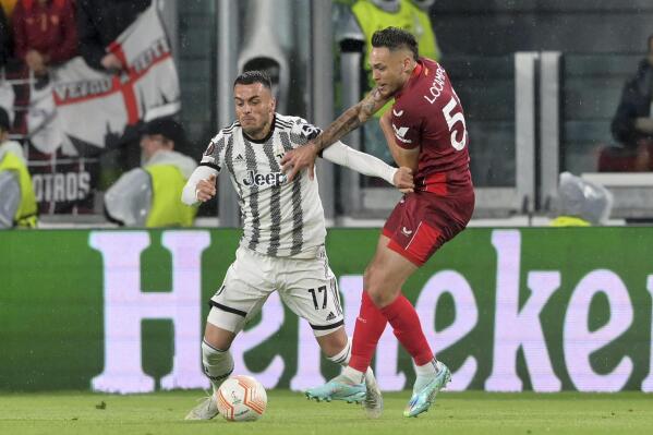 Juventus' Filip Kostic, left, and Sevilla's Lucas Ocampos battle for the ball during the Europa League soccer match between Juventus and Sevilla at Allianz Stadium in Turin, Italy, Thursday May 11, 2023. (Tano Pecoraro/LaPresse via AP)