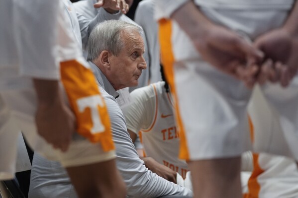 Tennessee head coach Rick Barnes huddles his players during a timeout in the first half of an NCAA college basketball game against Mississippi State at the Southeastern Conference tournament Friday, March 15, 2024, in Nashville, Tenn. (AP Photo/John Bazemore)