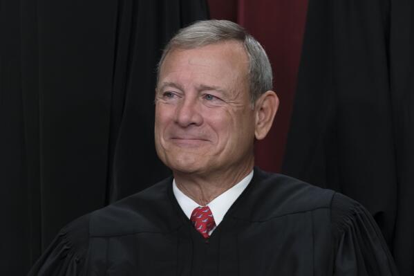 FILE - Chief Justice of the United States John Roberts joins other members of the Supreme Court as they pose for a new group portrait, at the Supreme Court building in Washington, Oct. 7, 2022. (AP Photo/J. Scott Applewhite, File)