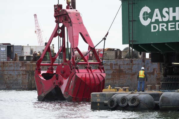 FILE - Workers remove wreckage of the collapsed Francis Scott Key Bridge, April 25, 2024, in Baltimore. A Maryland board led by Gov. Wes Moore approved a $50.3 million emergency contract on Wednesday, July 3, 2024, with a company that removed debris from the March collapse of the Francis Scott Key Bridge. (ĢӰԺ Photo/Matt Rourke, File)