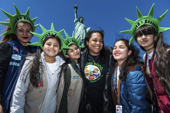 This photo provided by Girl Scouts of Greater New York shows Girl Scouts Troop 6000 paying a visit to the Statue of Liberty in New York in 2023. Troop 6000 has served kids who live in New York's shelter system since 2017, quietly welcoming hundreds of the city’s youngest new residents with the support of donations. (Kelly Marsh/Girl Scouts of Greater New York via AP)