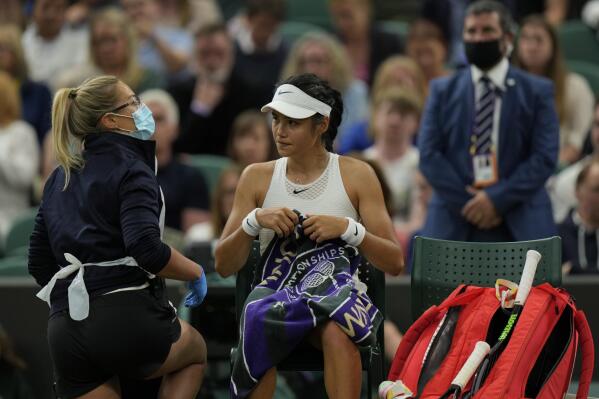 Britain's Emma Raducanu receives medical attention during the women's singles fourth round match against Australia's Ajla Tomljanovic on day seven of the Wimbledon Tennis Championships in London, Monday, July 5, 2021. (AP Photo/Alastair Grant)