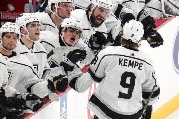 Los Angeles Kings' Adrian Kempe (9) returns to the bench after scoring his second goal of the third period during an NHL hockey game against the Pittsburgh Penguins in Pittsburgh, Sunday, Feb. 18, 2024. (AP Photo/Gene J. Puskar)
