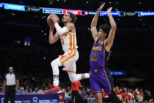 Atlanta Hawks' Trae Young (11) goes up for a basket past Los Angeles Lakers' Max Christie (10) during the second half of an NBA basketball game Friday, Jan. 6, 2023, in Los Angeles. The Lakers won 130-114. (AP Photo/Jae C. Hong)