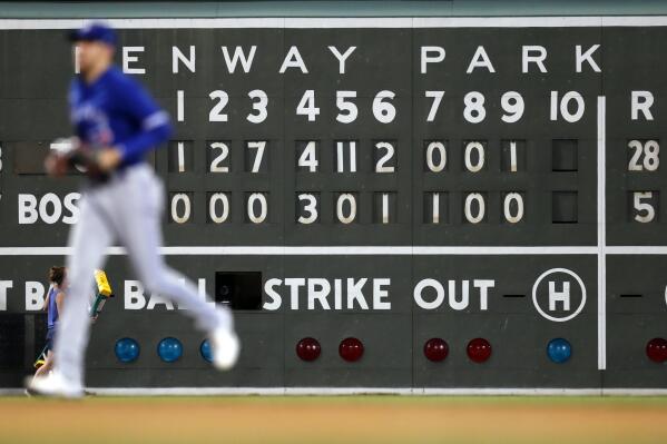 Toronto Blue Jays' Lourdes Gurriel Jr. runs past the scoreboard after the Blue Jays defeated the Boston Red Sox 28-5 ub a baseball game Friday, July 22, 2022, in Boston. (AP Photo/Michael Dwyer)