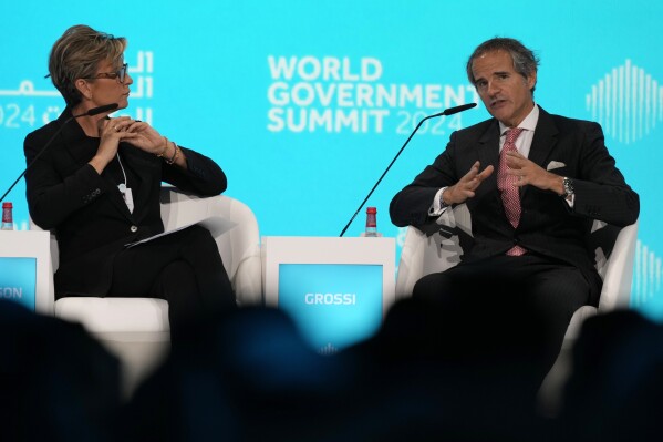 Rafael Mariano Grossi, right, the director-general of the International Atomic Energy Agency, talks to CNN's anchor Becky Anderson during the World Governments Summit in Dubai, United Arab Emirates, Tuesday, Feb. 13, 2024. The head of the United Nations' nuclear watchdog warned Tuesday that Iran is "not entirely transparent" regarding its atomic program, particularly after an official who once led Tehran's program announced the Islamic Republic has all the pieces for a weapon "in our hands." (AP Photo/Kamran Jebreili)