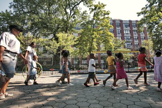 FILE - Children from a nearby daycare are escorted in Marcus Garvey Park in the Harlem neighborhood of New York Wednesday, Aug. 1, 2007. Some states have moved ahead with plans of their own to boost child care subsidies after a national effort by Democrats in Washington stalled. New York lawmakers passed a state budget in the spring that calls for it to spend $7 billion making child care more affordable over the next four years. (AP Photo/Bebeto Matthews, File)