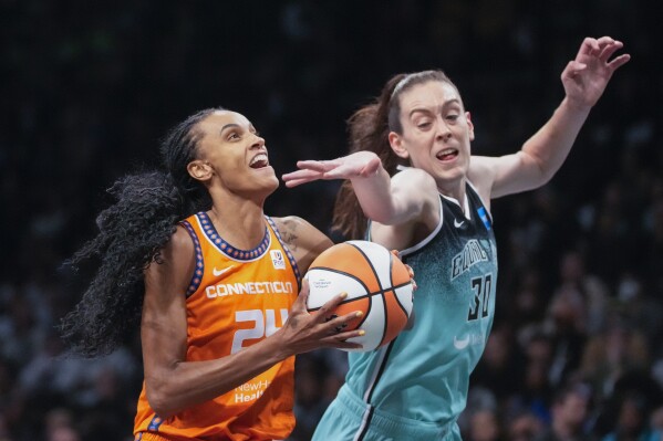 Connecticut Sun forward DeWanna Bonner (24) goes to the basket against New York Liberty forward Breanna Stewart (30) during the first half of Game 2 of a WNBA basketball playoffs semifinal Tuesday, Sept. 26, 2023, in New York. (AP Photo/Mary Altaffer)