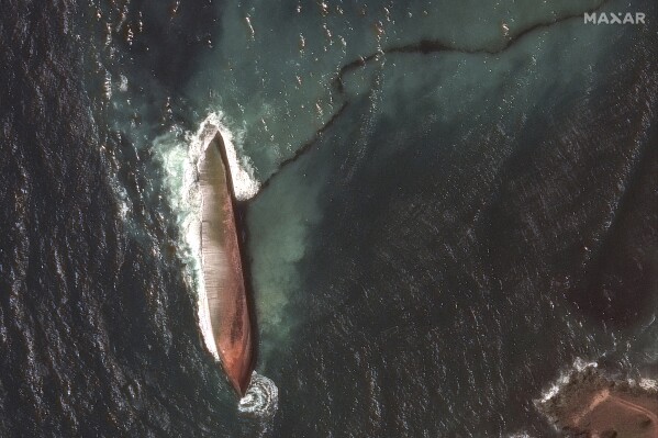 This satellite image provided by Maxar Technologies shows an oil spill caused by an overturned vessel off the coast of Tobago near Scarborough, Trinidad and Tobago, Wednesday, Feb. 14, 2024. (Maxar Technologies via AP)