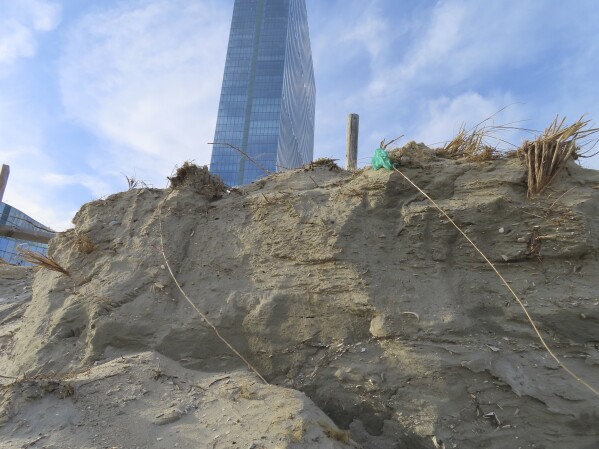 This March 13, 2024 photo shows an eroded beach in front of the Ocean Casino Resort in Atlantic City, N.J. The Ocean, Resorts and Hard Rock casinos want the federal government to accelerate a beach replenishment project so that they have usable beaches this summer, but the U.S. Army Corps of Engineers says it could be fall before the work begins. (AP Photo/Wayne Parry)