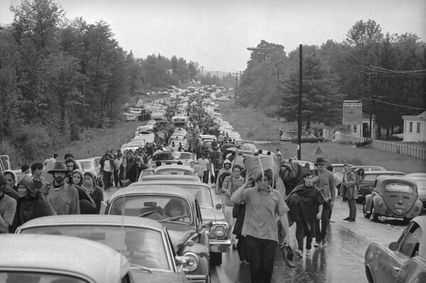 FILE - Hundreds of rock music fans get stuck on the highway out of Bethel, New York, on Aug. 16, 1969, as they try to leave the Woodstock Music and Arts Festival.  (AP Photo, file)