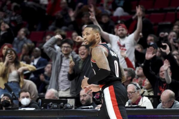 Portland Trail Blazers guard Damian Lillard, heads back up the court after scoring during the second half of an NBA basketball game against the Houston Rockets in Portland, Ore., Sunday, Feb. 26, 2023. (AP Photo/Steve Dykes)