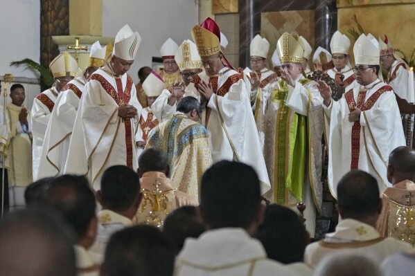 Bishops take part in the ordination ceremony of Paulus Budi Kleden as the new bishop of Ende, at the Christ the King Cathedral church in Ende, East NusaTenggara province, Indonesia, Thursday, Aug. 22, 2024. (AP Photo/Tatan Syuflana)