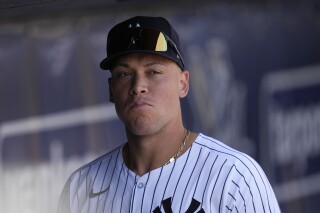 New York Yankees center fielder Aaron Judge walks in the dugout before a spring training baseball game against the Atlanta Braves Sunday, March 10, 2024, in Tampa, Fla. (AP Photo/Charlie Neibergall)