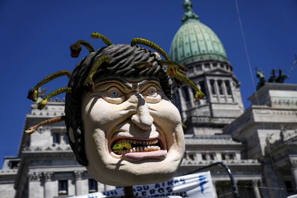 An effigy of Argentine President Javier Milei is covered in snakes outside Congress where protesters marched during a national strike against economic and labor reforms proposed by Milei's government in Buenos Aires, Argentina, Wednesday, Jan. 24, 2024. (AP Photo/Rodrigo Abd)