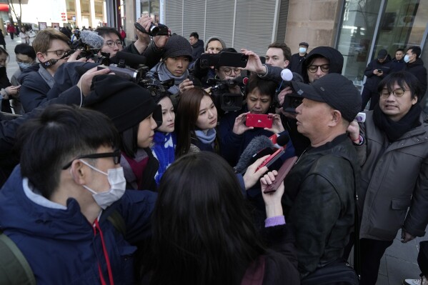 Li Shuce, bottom right, whose son was onboard the missing Malaysian Airline MH370, speaks to journalists near the Ministry of Foreign Affairs in Beijing, Friday, March 8, 2024. Ten years on, families of Chinese passengers who were on a vanished Malaysian Airline flight still are searching for answers. Friday marks the 10th anniversary of the disappearance of flight MH370. The Boeing 777 left Kuala Lumpur bound for Beijing with 239 people on board on March 8, 2014, but took a sharp turn south and fell off the radar. It never made it to Beijing. (AP Photo/Ng Han Guan)