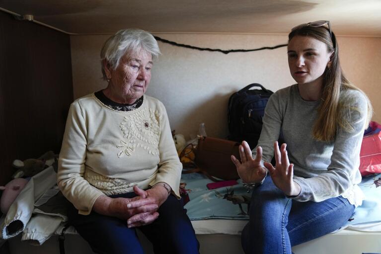 Olha Exharzo and her 26-year-old granddaughter, Olha Exharzo. sit together inside their cabin in the ferry Isabelle in Tallinn, Estonia, Wednesday, June 15, 2022. Four generations of the Exharzo family left Mariupol on April 12. (AP Photo)